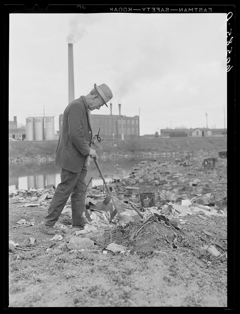 Residents of shack town making daily round through the city dump looking for anything of value. Dubuque, Iowa. Sourced from…