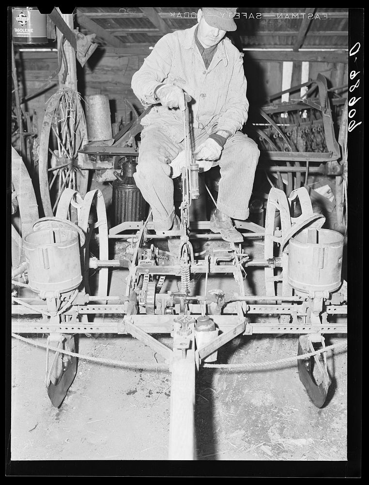 [Untitled photo, possibly related to: Filling box on two-row corn planter. Grundy County, Iowa]. Sourced from the Library of…