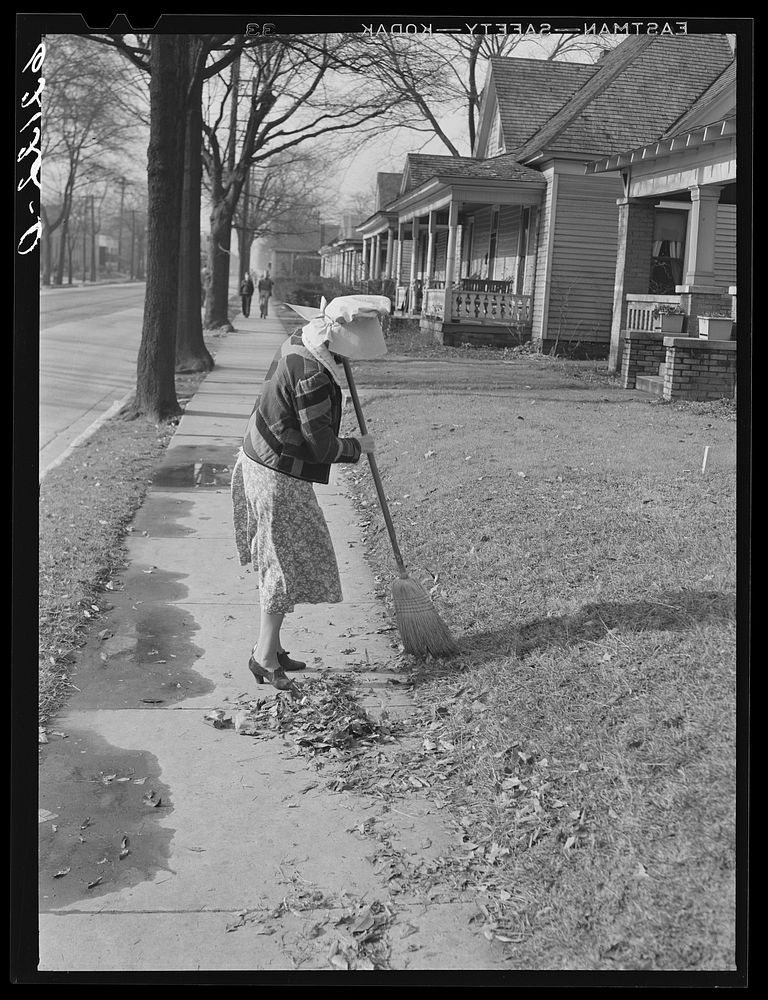 Woman sweeping leaves. Birmingham, Alabama. Sourced from the Library of Congress.