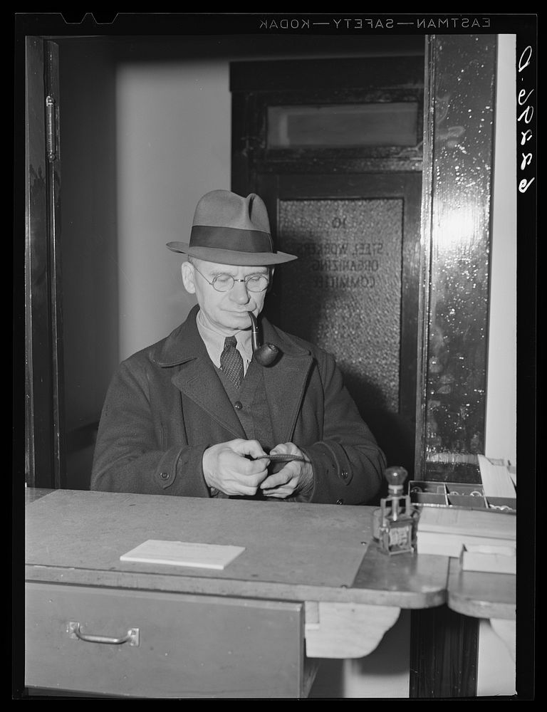 Steelworker paying dues at steelworkers organizing committee office. Ambridge, Pennsylvania. Sourced from the Library of…