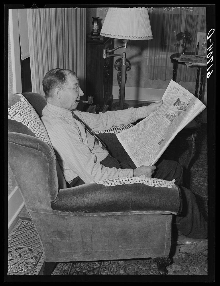 L.M. Schulstad, traveling saleman for hardware company, reading the editorials. Aberdeen, South Dakota. Sourced from the…