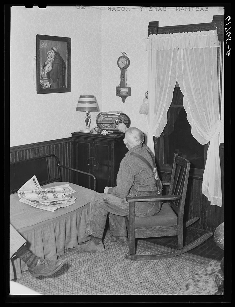 Farmer tuning in radio. Meeker County, Minnesota. Sourced from the Library of Congress.
