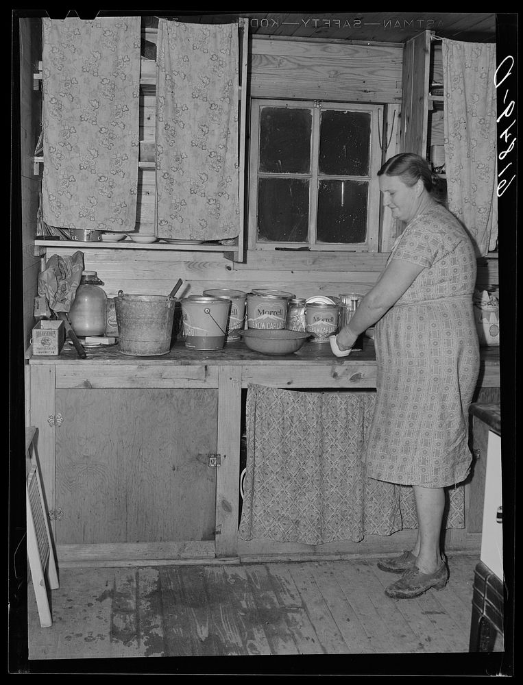 Wife of agricultural day laborer in kitchen of one of the new scattered labor homes built by FSA (Farm Security…