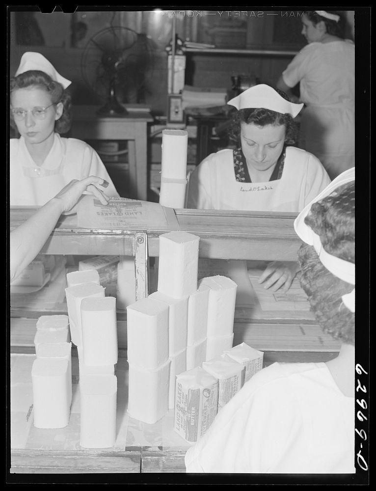 [Untitled photo, possibly related to: Wrapping butter by hand. Land O'Lakes plant, Chicago, Illinois]. Sourced from the…