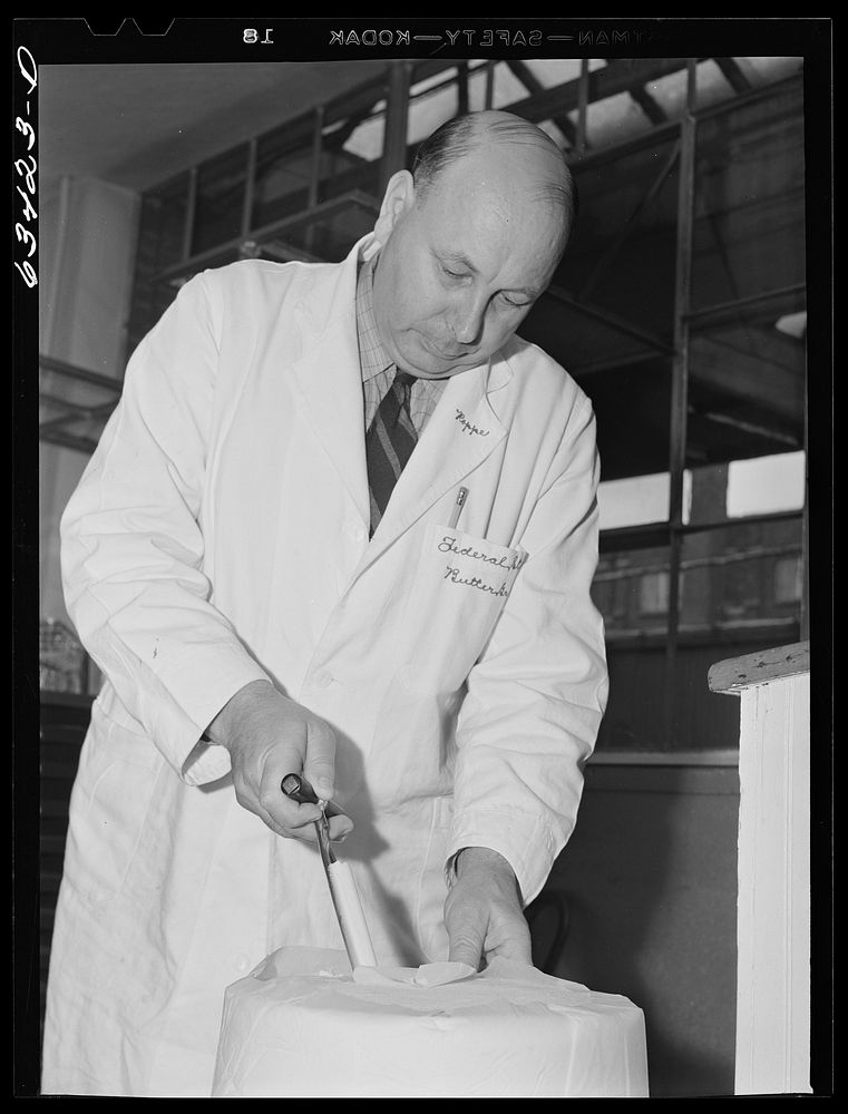 Federal inspector taking sample of tub butter. Land O'Lakes plant, Minneapolis, Minnesota. Sourced from the Library of…