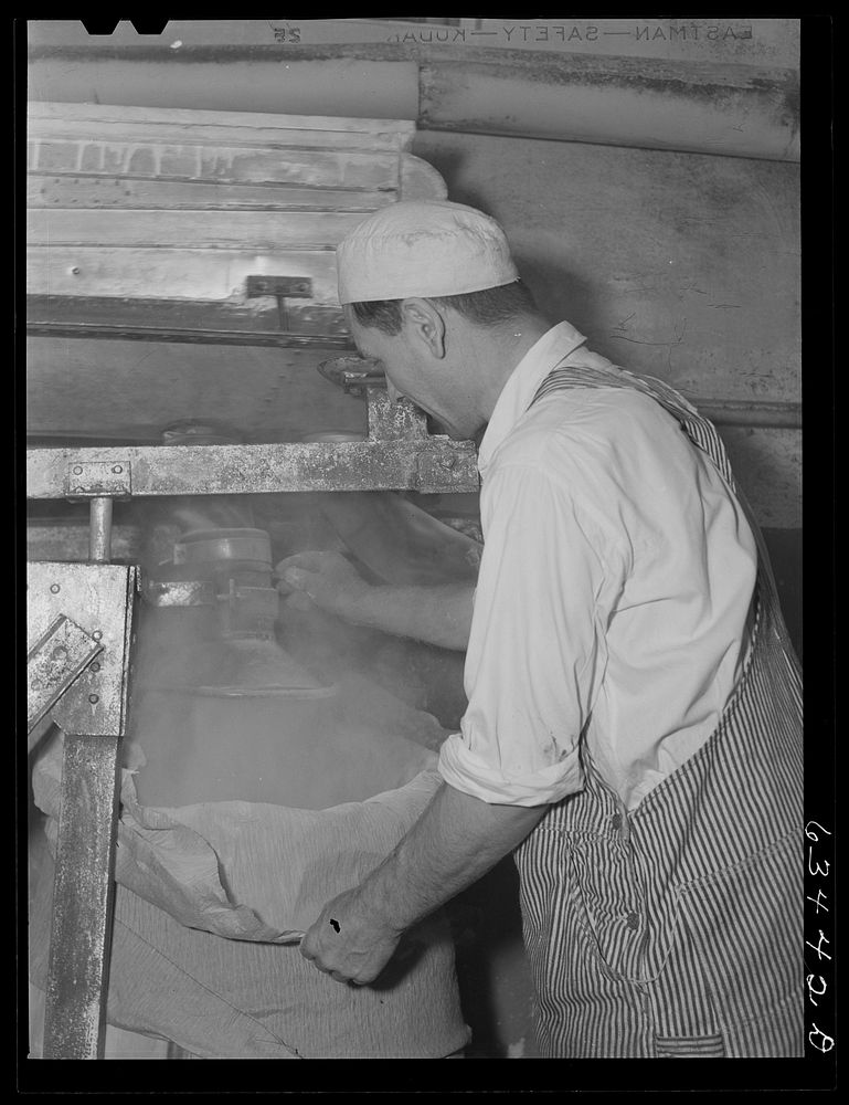 Filling barrel with powdered milk at condensary. Antigo, Wisconsin. Sourced from the Library of Congress.