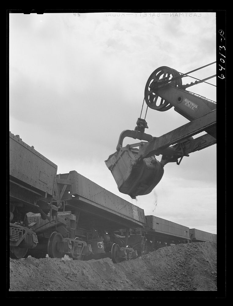 Loading iron ore into seventy ton cars. Danube Mine near Bovey, Minnesota. Sourced from the Library of Congress.