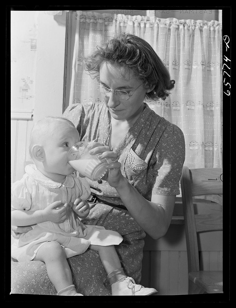 Lancaster County, Nebraska. Mrs. Pierce giving her daughter a glass of milk. Sourced from the Library of Congress.