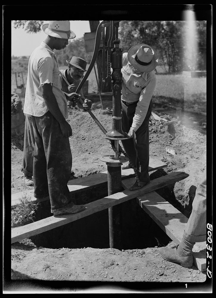 Pump is settled onto pump rod and drop pipe. Pipe wrench still keeps drop pipe from slipping into well. John Fredrick well…
