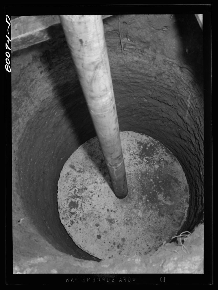 Metal casing threaded into cement cap ten feet down. Charles County, Maryland. Hardesty well project. Sourced from the…
