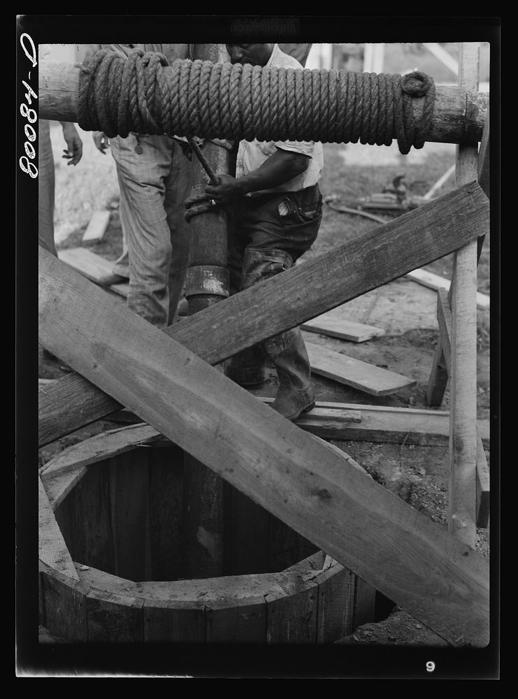 Lowering five foot steel casing into well. Safe well demonstration near La Plata, Maryland. Charles County. Sourced from the…
