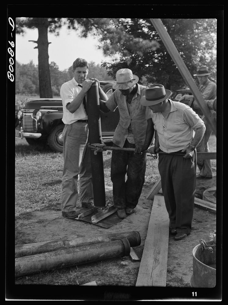 A steel plate with a pipe coupling is placed on the culvert cap. Safe well demonstration near La Plata, Maryland. Charles…