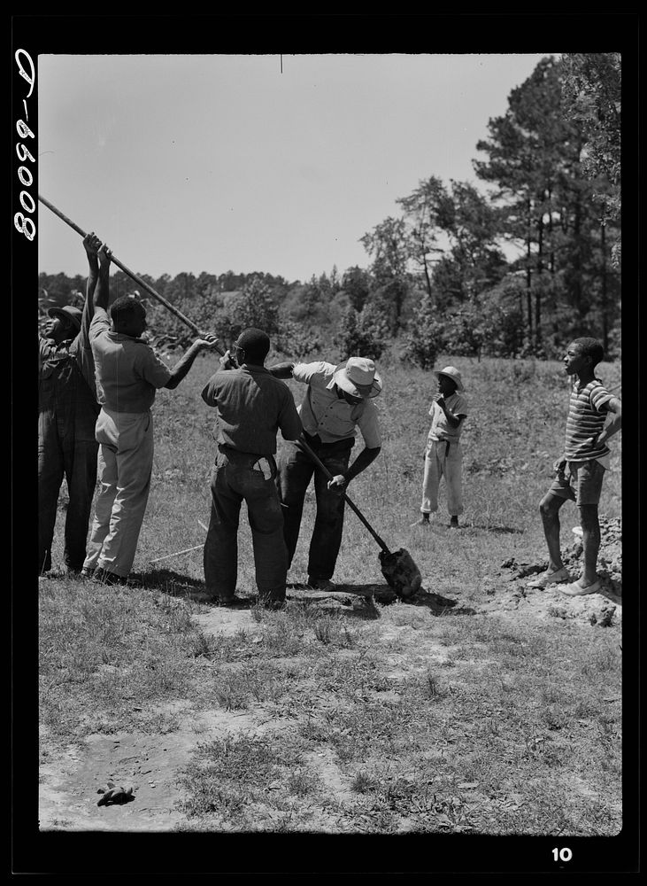 Removing a load of soil from auger as taken from well. Safe well demonstration, Ridge, Saint Mary's County, Maryland.…