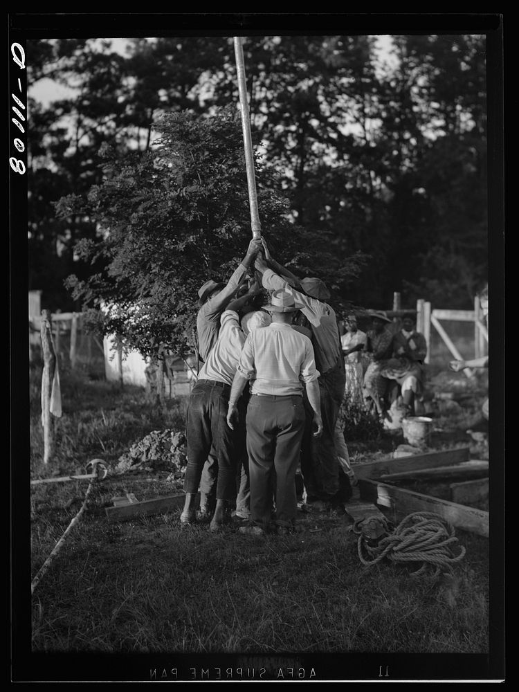 Drop pipe is lowered into casing. Ridge well project, Saint Mary's County, Maryland. Sourced from the Library of Congress.