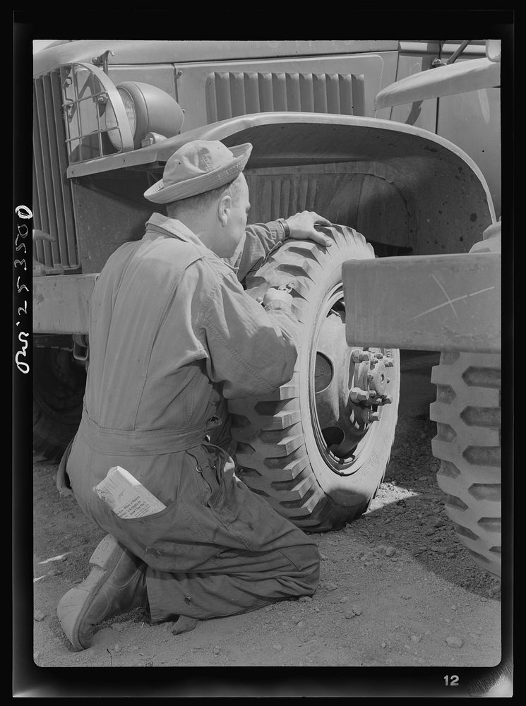 Holabird ordnance depot, Baltimore, Maryland. A soldier removing a tack from a United States Army truck tire. Constant fire…