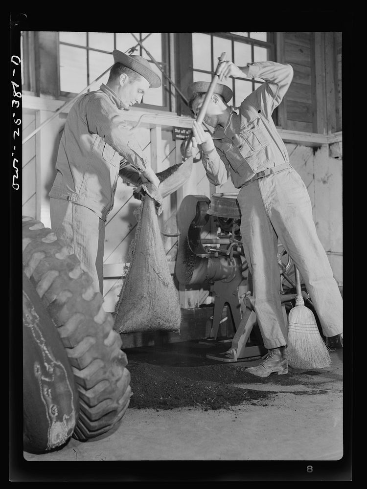 Holabird ordnance depot, Baltimore, Maryland. Soldier sweeping up the buffing dust in the recapping shop which will be…