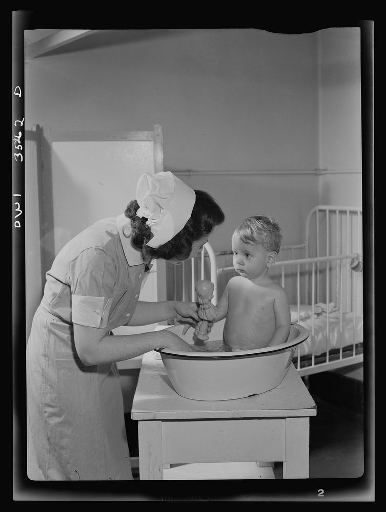 Johns Hopkins Hospital, Baltimore, Maryland. Student nurse at work in the pediatric ward. Sourced from the Library of…