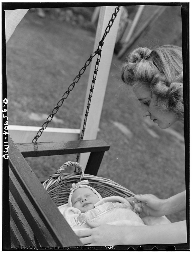 Washington, D.C. Lynn Massman, wife of a second class petty officer who is studying in Washington, D.C. puts eight weeks old…