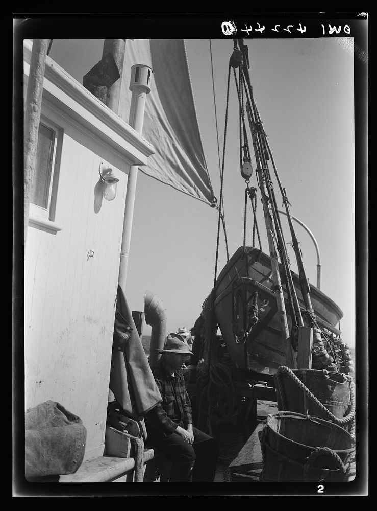 On board a fishing vessel out from Gloucester, Massachusetts. The power house, a riding sail, marker bouys, and canvas…