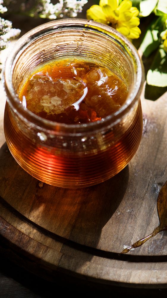 Food phone wallpaper background, organic honey in a glass jar