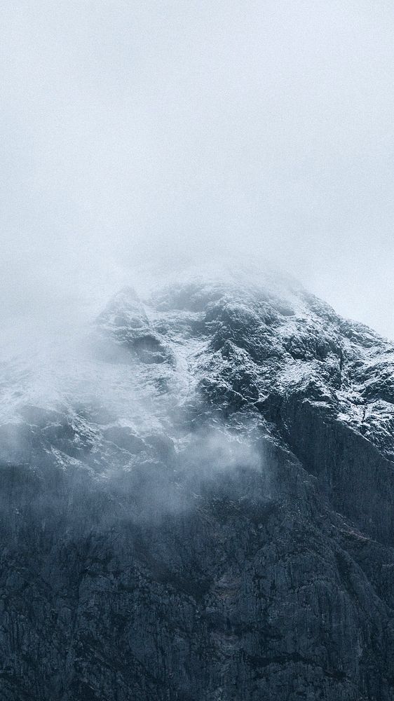 Nature phone wallpaper background, snowy mountain on a misty day
