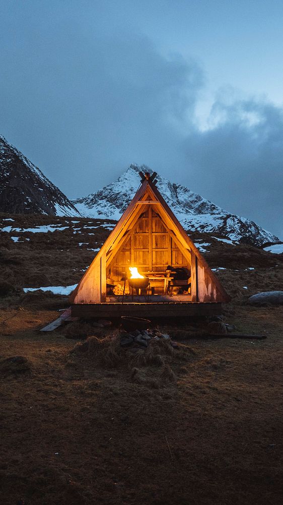Adventure mobile wallpaper background, fire pit in a wooden hut on Lofoten island, Norway