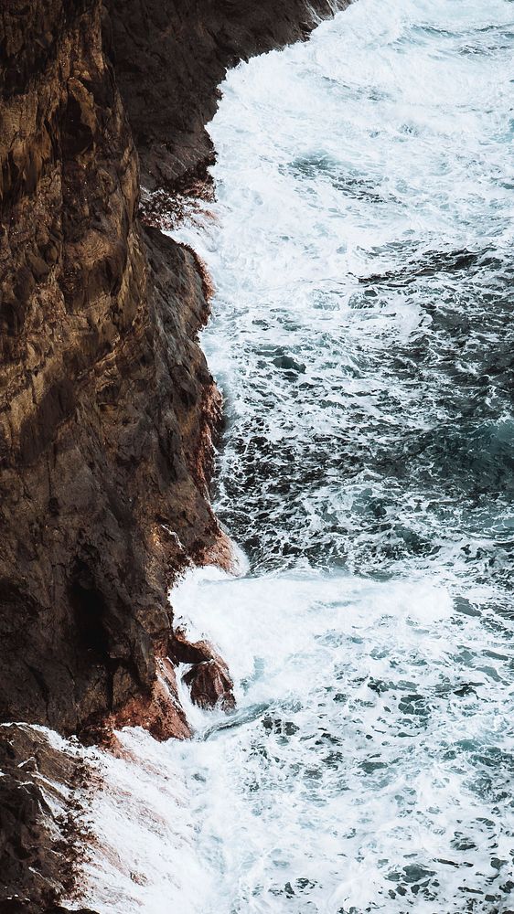 Ocean mobile wallpaper background, waves hitting the cliffs in the Faroe Islands