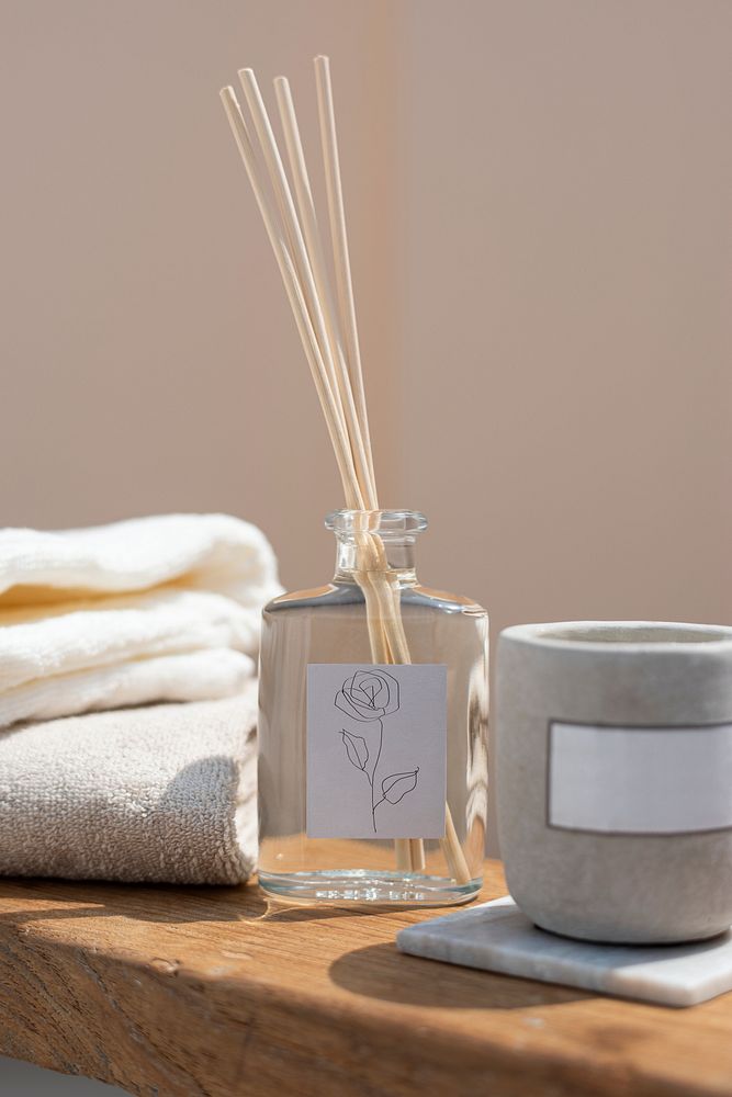 Reed diffuser bottle and aroma candle in a spa