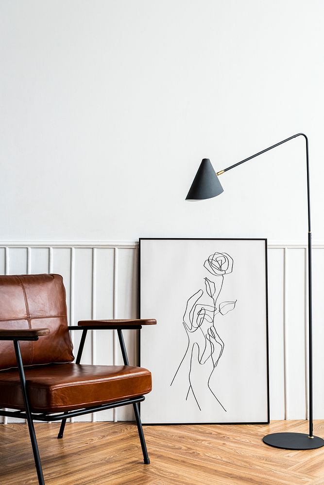 Picture frame with line art by a lamp in a living room