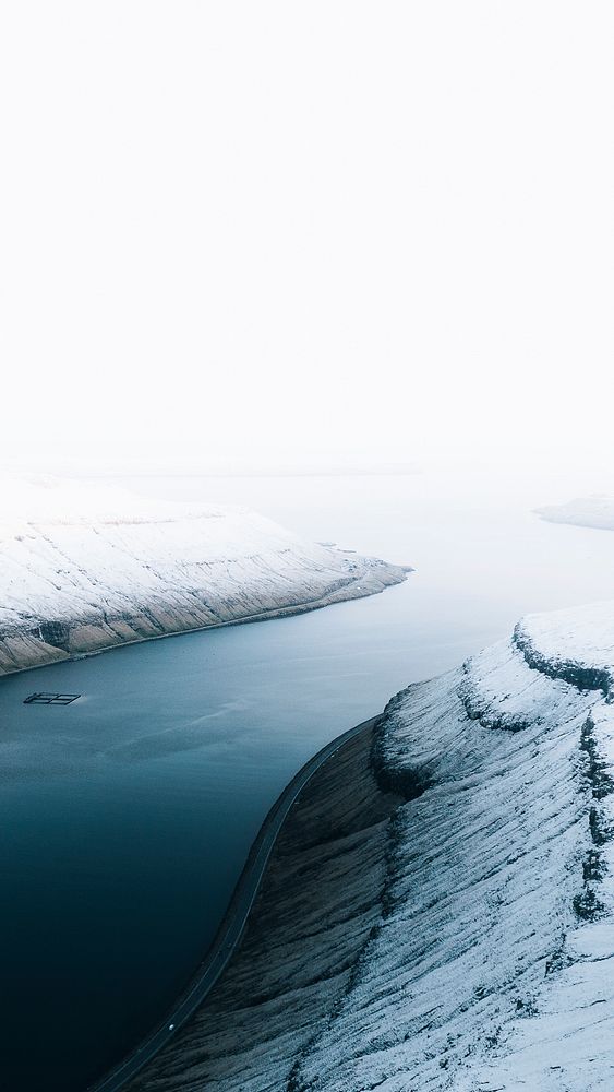 Winter mobile wallpaper background, lake through a snowy mountain