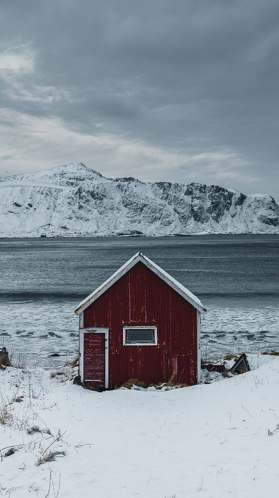 Winter mobile wallpaper background, red cabin on a snowy shore