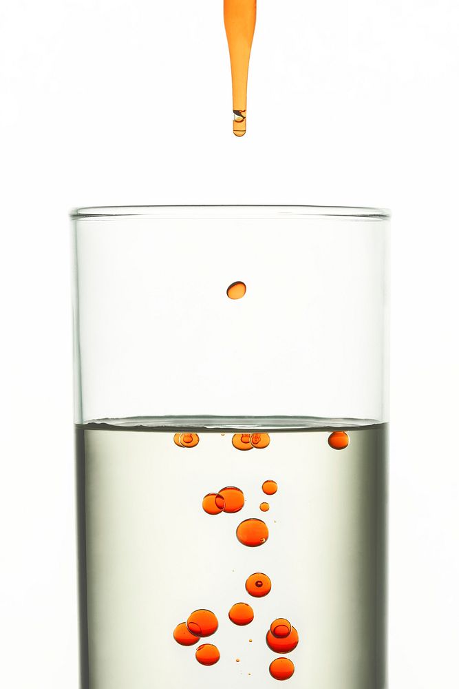 Science background, orange oil drops in water wallpaper