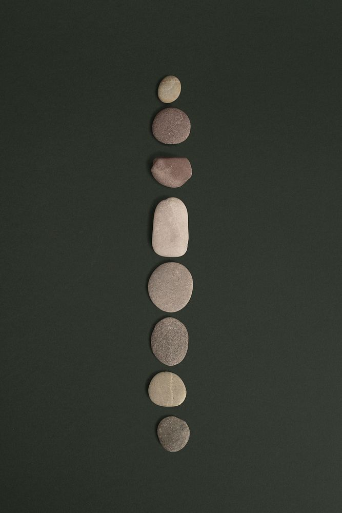 Zen stones psd stacked on green background in health and wellbeing concept