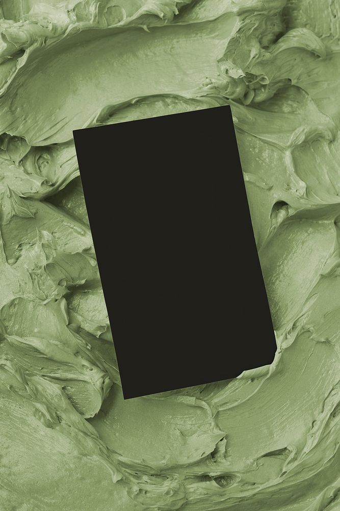 Black business card on green frosting texture