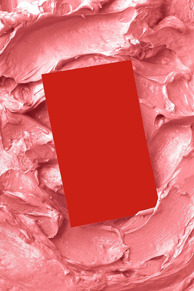 Red business card on pink frosting texture