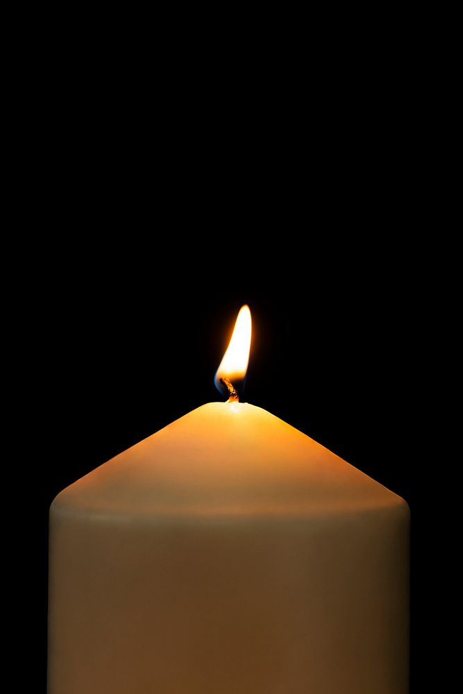Burning candle light realistic flame, black background high resolution image