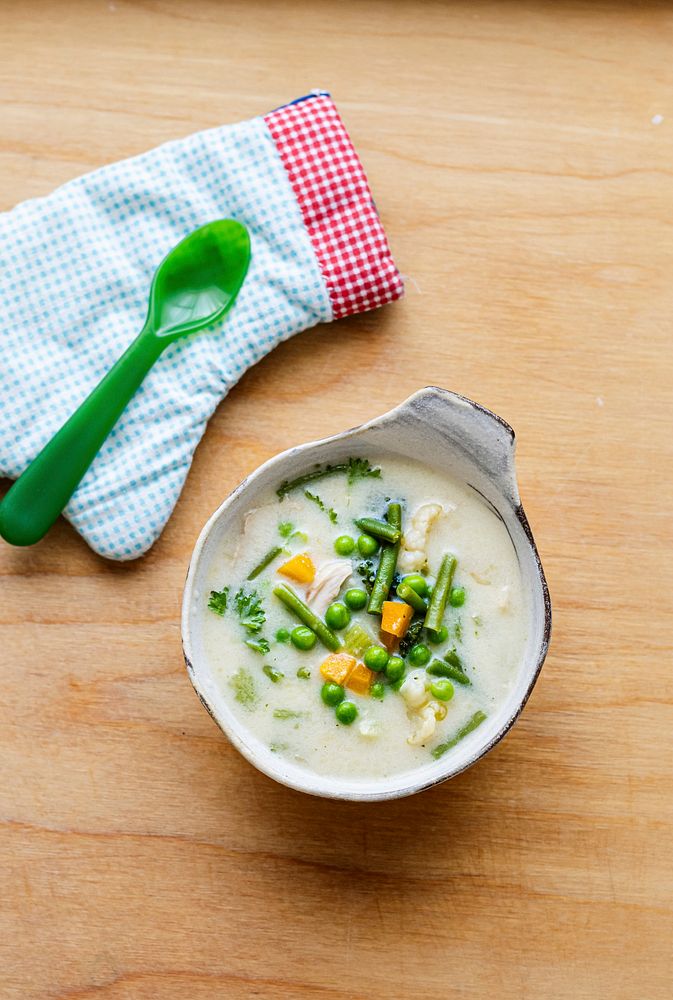 Kids healthy chicken soup with peas and carrots 