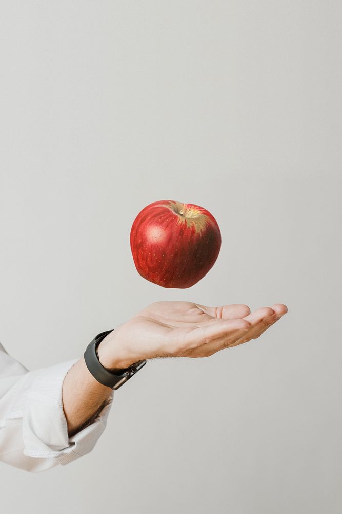 Red apple above student&rsquo;s hand