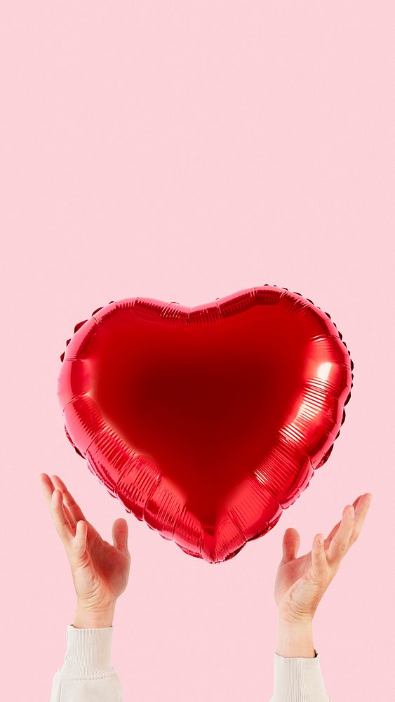 Valentines heart balloon held by a person