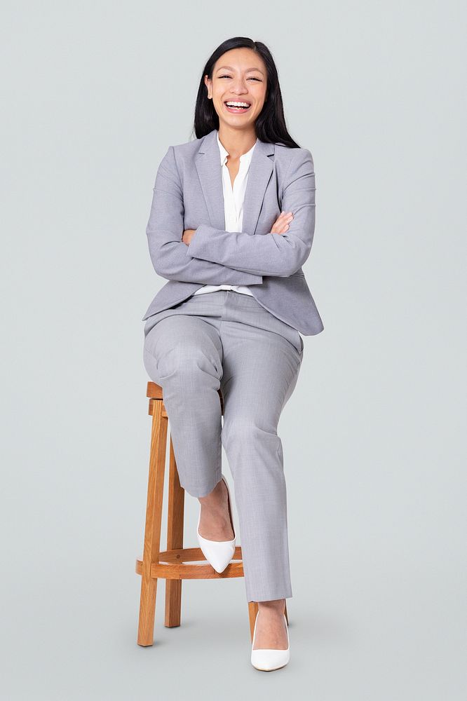 Cheerful businesswoman sitting on a wooden stool jobs and career campaign