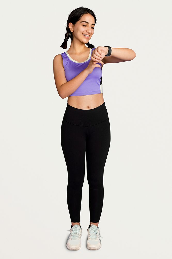 Sporty woman checking fitness tracker psd