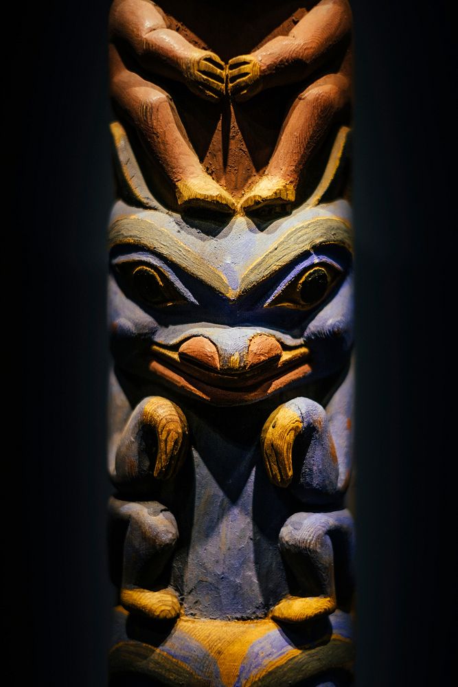 A scary totem pole made of wood in a museum in Musée d'Ethnographie de Genève (MEG). Original public domain image from…