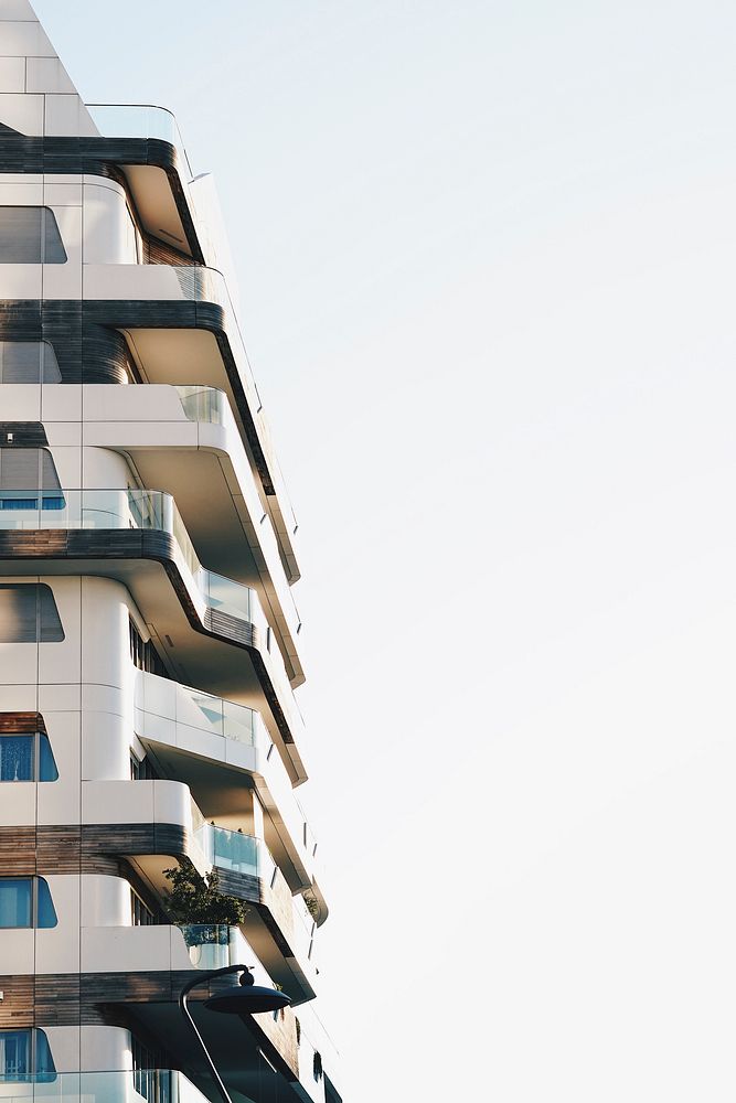 Building with modern architecture and balconies with clear sky and windows in Milan. Original public domain image from…