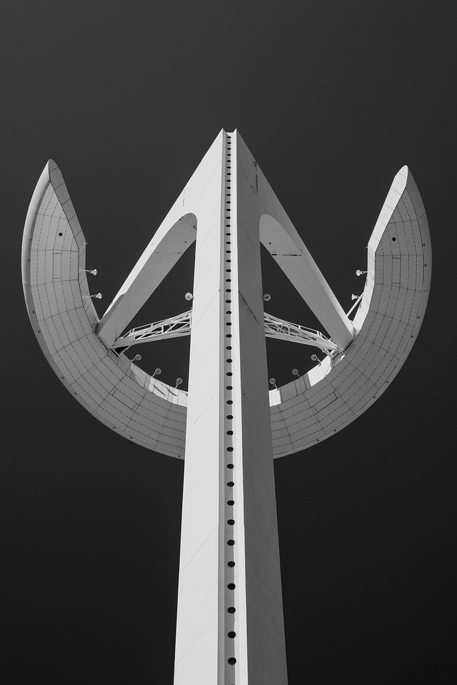 Black and white shot of Montjuïc communications tower from below in Barcelona. Original public domain image from Wikimedia…