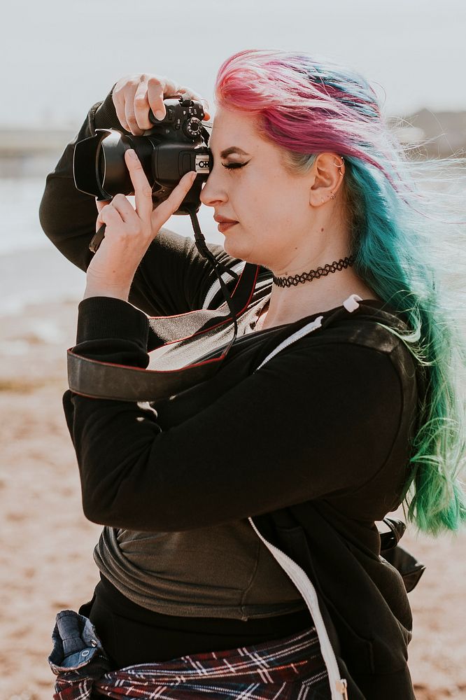 Artsy woman taking a photo at a beach