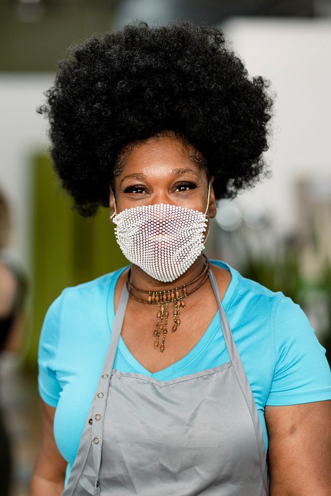 Smiling woman wearing a mask during the new normal 