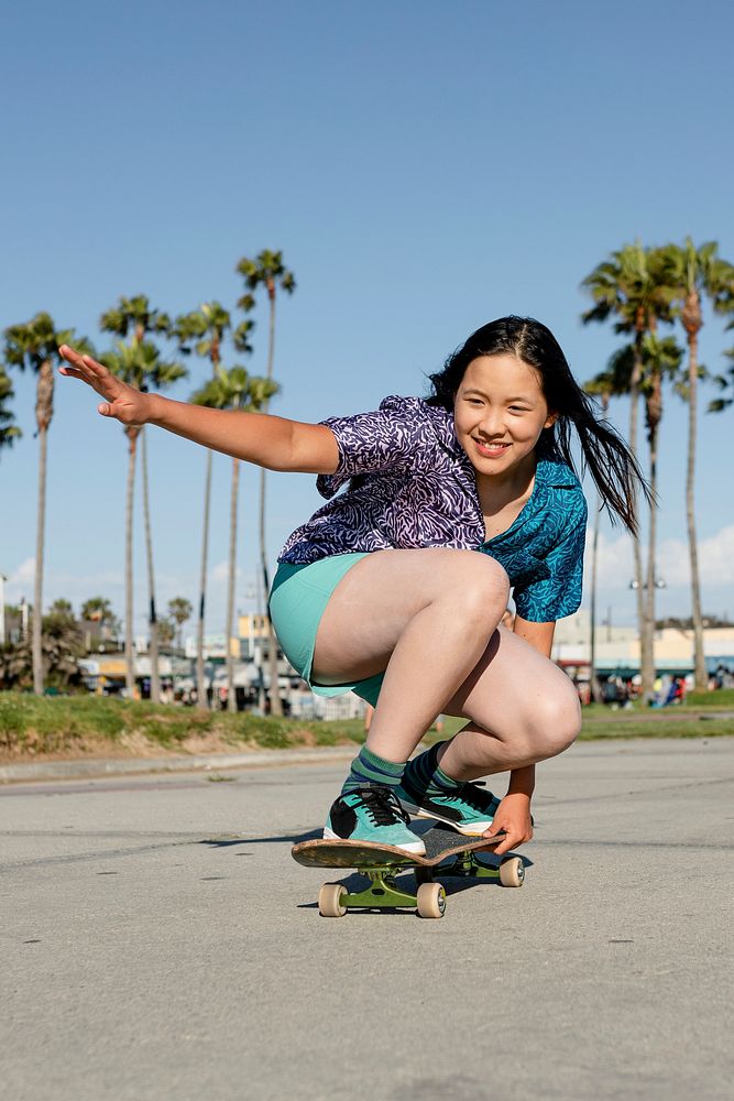Teen girl skateboarding, fun outdoors sport activity
