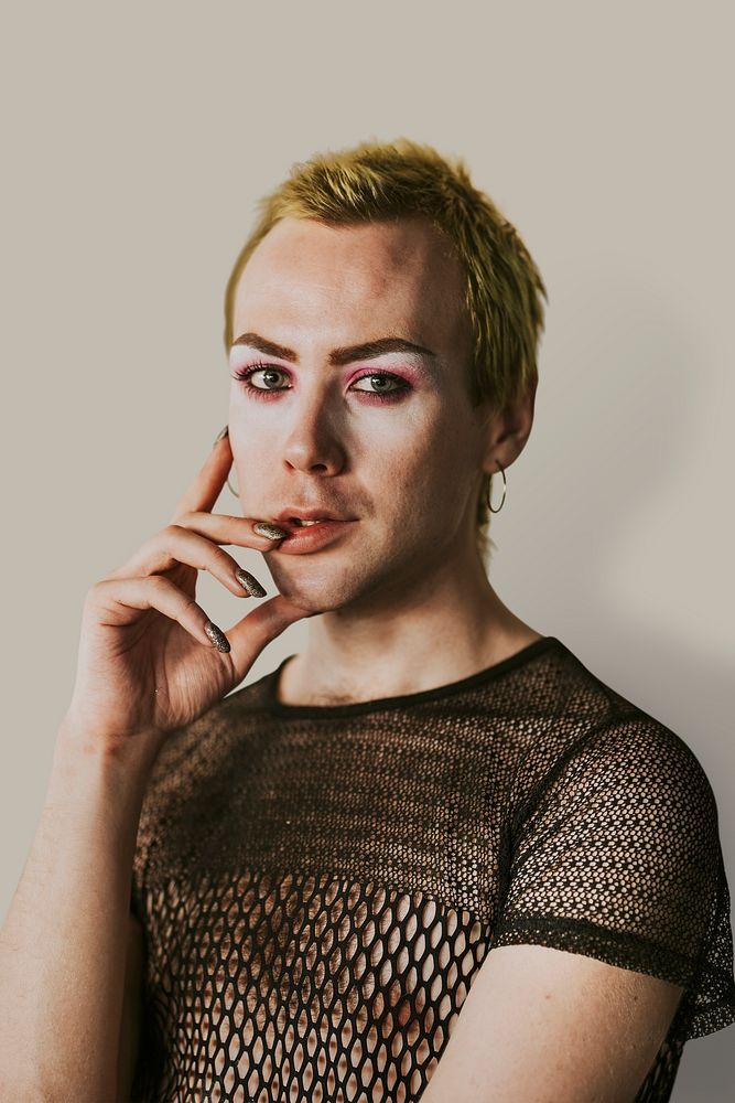 Blond non-binary person wearing makeup portrait