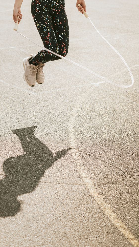 Aesthetic phone wallpaper, girl jumping rope at basketball court