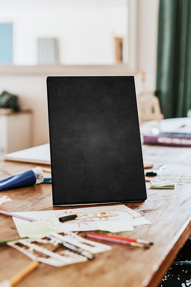 Blank chalk board on wooden table